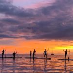 rainbow watersports standup paddle boarding ocean sunset oahu hawaii